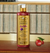 Frasco de Shampoo Clareador Tonalizante Ametista Bambu 500ml da Dolce Pet, com rótulo colorido e tampa dourada, sobre uma superfície de madeira.