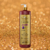 Frasco de Shampoo Clareador Tonalizante Ametista Cereja e Avelã 1L da Dolce Pet sobre fundo dourado.
