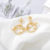 Aretes Planeta y Estrellas Micro Pavé Zirconias Baño Oro 18k - Moda Turín