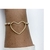 Pulseira de Pérolas com Coração Vazado Central Banhada em Ouro 18k na internet