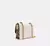 Imagen de Bolso Coach Klare Crossbody Logo Canvas Remaches Beige Dorad