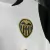 camisa-valencia-home-titular-i-1-branca-preta-dourada-24-25-puma-torcedor-unissex-gola-redonda-tm-real-estate-group-divina-seguros-kit-infantil-short-branco-2.jpg