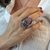 ANEL OVAL CRISTAL AMETISTA COM ZIRCÔNIAS BRANCAS RÓDIO NEGRO - loja online