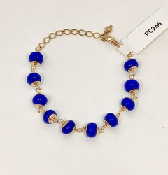 Pulseira dourada com esferas em vidro azul royal - comprar online