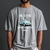 Camiseta cinza com estampa de um Fusca azul, texto "THE LEGEND" e "VINTAGE NEVER DIE 1938".