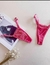 Calcinha fio dental tradicional em renda rosa pink com alças finas ajustáveis.