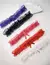 Conjunto de persex de renda em várias cores: roxo, preto, rosa, vermelho e branco, com laços delicados.