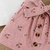 Imagem do Conjunto blusa branca com babados e saia rosa com botões e estampa floral