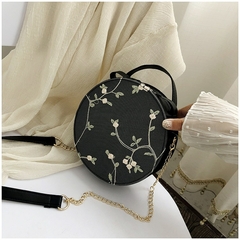 Bolsa transversal redonda de couro sintético