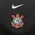 Camisa do Corinthians Away 25/26, predominantemente preta com mangas brancas e logo do time em destaque.