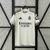 Camisa Home do Real Madrid 25/26, predominantemente branca, com detalhes em amarelo e logo da Adidas.