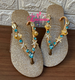 Slin glitter dourada com peça mar azul