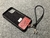Image of Lujosa Funda y Soporte Universal para iPhone de Cuero Genuino Full-Grain curtido vegetal al tanino & Correa/Pulsera de Cuerda Elástica Negra.- SPI54
