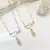 Colar Bolinhas Escrita Mãe de Menina com Zircônia Rosa - Semijoia Ouro 18K na internet