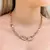 Imagem do Conjunto Elos e Detalhes de Zircônias no Centro - Semijoia Ouro 18K