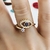 Anel Olho Grego com solitário no mesmo aro cravejado em micro zircônias cristal e marinho banho Ouro 18k (AN1605) - comprar online