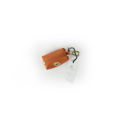 porta saquinhos importado de luxo em couro laranja com acabamento dourado para animal de estimação