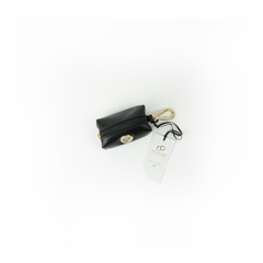 porta saquinhos importado de luxo em couro preto com acabamento dourado para animal de estimação

