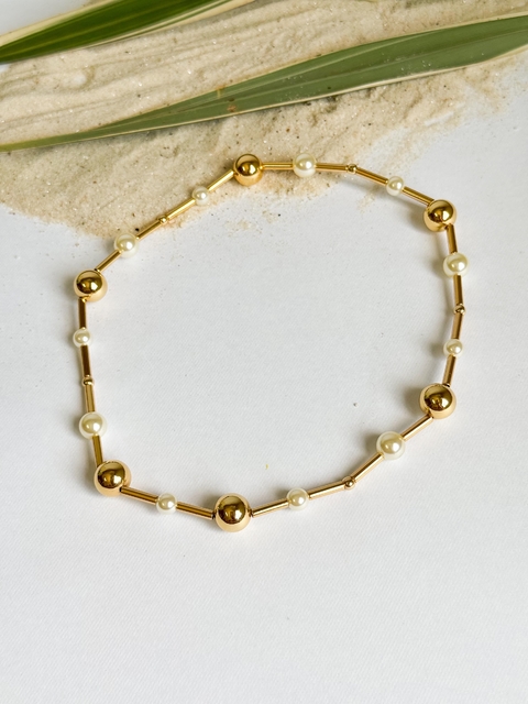 Pulseira de pérola com esfera dourado
