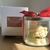 Pote de Natal com decoração de Papai Noel e árvore de Natal em um recipiente transparente.
