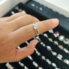 Anillo con Piedra Blanca Encastrada con Detalles en Oro.