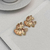 BRINCO FLOR BANHADO NO OURO ROSE 18 K na internet