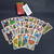 Baralho Cigano Lenormand da Rosalinda da Matta, com cartas expostas e embalagem em fundo escuro.