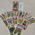 Baralho Cigano Lenormand da Rosalinda da Matta, com cartas expostas e embalagem em fundo escuro.