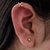 Arete clip piercing cruzado