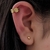 Arete clip piercing símbolo chino de riqueza
