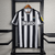 Camisa-Newcastle-I-23_24-Torcedor-Castore-Masculina-Branco-e-Preto-preta-branca-masculino-1-bruno-guimarães-Joelinton-original-comprar-premier-league-listra-listrada-listras-sela-Magpies-gola-v