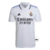 Camisa do Real Madrid 2022/23, modelo torcedor masculino, na cor branca, com detalhes em azul e logotipo da Adidas.