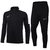 Conjunto de agasalho Nike Dri-Fit, composto por uma blusa de manga longa e calças, ambas na cor preta com detalhes em branco.