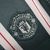 Camisa do Manchester United II da temporada 2023/24, modelo masculino, com listras verticais em verde e branco.