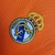 Emblema do Real Madrid bordado em uma camisa laranja retrô