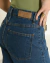 Calça jeans reta bolsos frontais com botões na internet