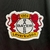 camisa-bayer-leverkusen-1-i-home-castore-torcedor-23-24-preta-vermelha-cruz-bundesliga-xabi-alonso-campeonato-alemao 