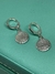Celebre sua fé com elegância e estilo com nosso Brinco Prateado Argola "Pai Nosso". Este brinco delicado combina a beleza clássica da argola prateada com a inscrição da oração "Pai Nosso", criando uma peça que é tanto uma expressão de devoção quanto uma d