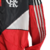 Jaqueta corta-vento masculina do Flamengo 23/24 da Adidas, nas cores vermelha e preta com detalhes em branco.