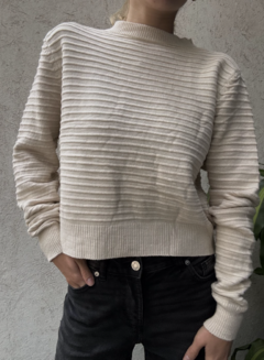 Sweater Costa color beige con textura de rayas horizontales, usado por persona con pantalones negros