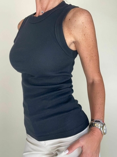 Musculosa Forli de color negro, con diseño de tirantes y ajuste ceñido, presentada en un fondo neutro.