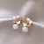 BRINCOS FLOR DE PÉROLA BANHADO A OURO 18K na internet