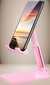 Suporte para celular e tablet portátil na cor rosa, ajustável, com um smartphone exibindo uma paisagem ao pôr do sol.