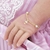 PULSEIRA BEBÊ PÉROLA COM GUARDA-CHUVA CRAVEJADO BANHADO EM OURO - comprar online