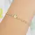 PULSEIRA INFANTIL DE BOLINHAS E UMA COROA DOURADA NO CENTRO na internet