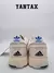 Zapatillas Adidas Bad Bunny Adizero SL 72 en color off white desde atrás, mostrando el diseño y logotipo distintivo.