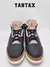 Zapatillas Jordan 3 Retro Desert Elephant en color negro y detalles en naranja.