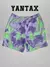 Shorts de la colaboración Puma x MELO, con diseño tóxico AOP en tonos púrpura y verde.