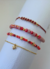 Mix de pulseras bordó con cristales, fimo y dijes de estrella en hilo y cadena de oro laminado 