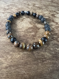 Pulsera de piedras naturales de ojo de tigre , piedras volcanicas y piedras obisidianas, enhebradas en tanza elastica. Diferentes talles para todas las medidas.